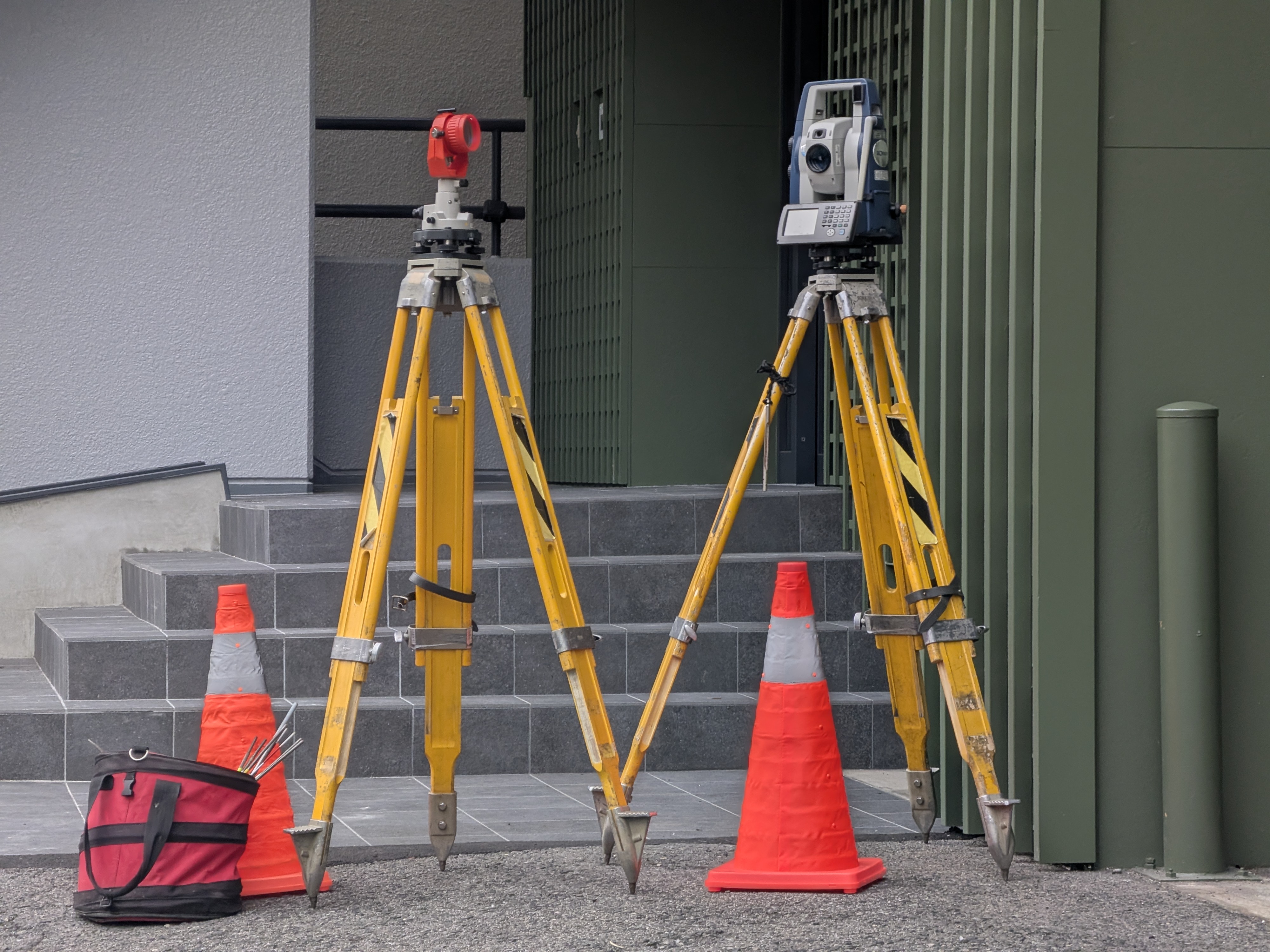 Surveyor with total station instrument carrying out land setting-out